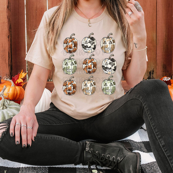 Cow Print Pumpkins DTF Heat Transfer, colorful and patterned pumpkin designs on a T-shirt for Halloween decoration.