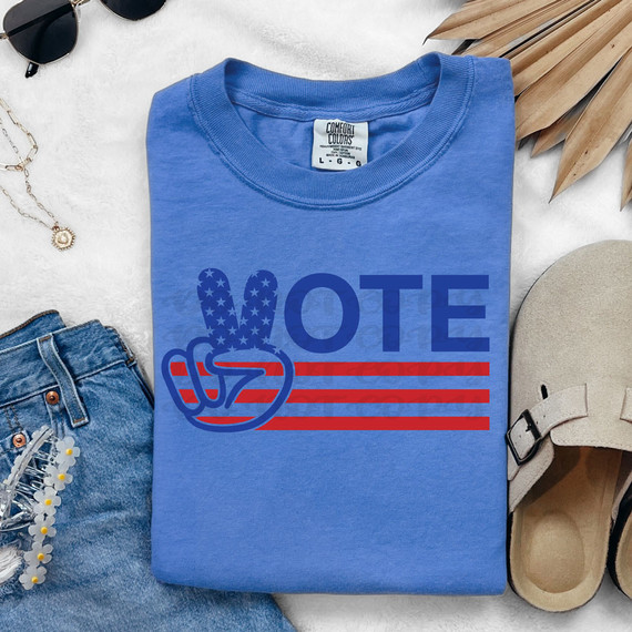 Vote Peace Sign DTF Heat Transfer, image of a blue t-shirt with a peace sign hand gesture and the word 'VOTE' in bold letters.