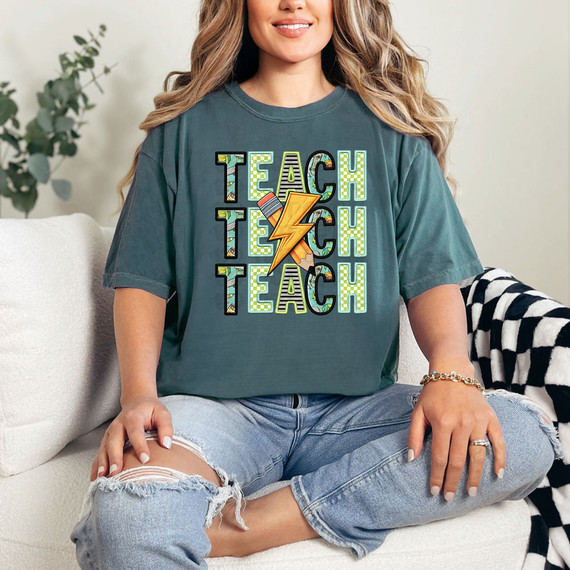 Teach Stacked Blue/Green DTF Heat Transfer, colorful and vibrant multicolor heat transfer design on a casual t-shirt worn by a smiling woman.