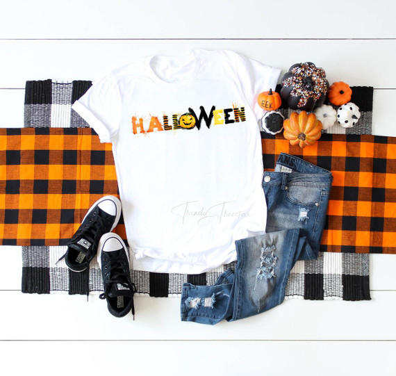 Halloween Word Art Sublimation Transfer, white T-shirt with colorful Halloween-themed word art design.