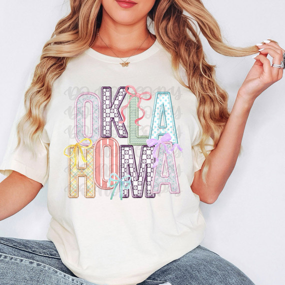 Oklahoma Coquette Faux Embroidery DTF Heat Transfer, colorful embroidered style text design on white T-shirt.