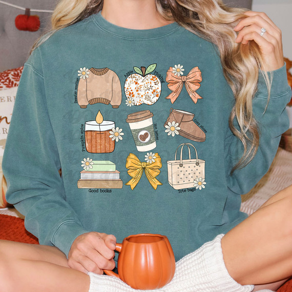 Fall Girly DTF Heat Transfer, printable design featuring autumn-themed icons like sweater weather, apple picking, bow, pumpkin spice candle, hot drinks, boots, good books, and tote bags, on a teal sweatshirt