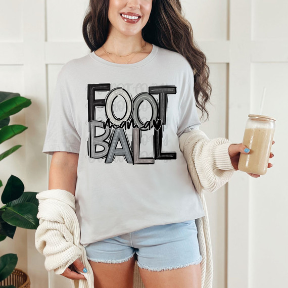 Football Mama Monochrome DTF Heat Transfer, a stylish white T-shirt with black and gray lettering and a heart design showing a football theme.