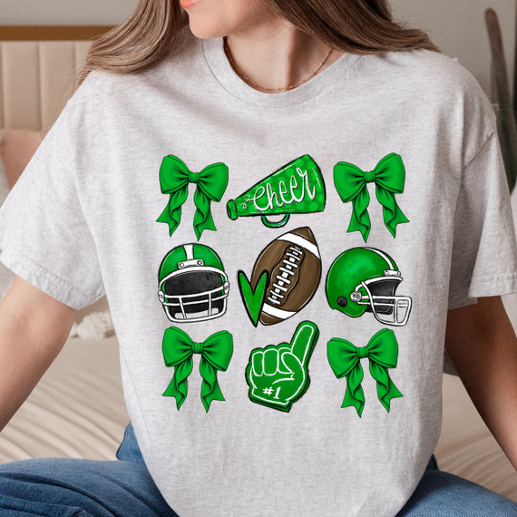 Green Cheer Bows DTF Heat Transfer, product design featuring green bows, football helmets, a football, a cheer megaphone with the word 'Cheer', and a foam finger with '#1' on a gray t-shirt.