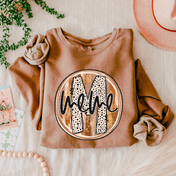 Meme Fall Brushstrokes DTF Heat Transfer, a colorful design featuring the letter M with brushstroke patterns on a beige sweatshirt.