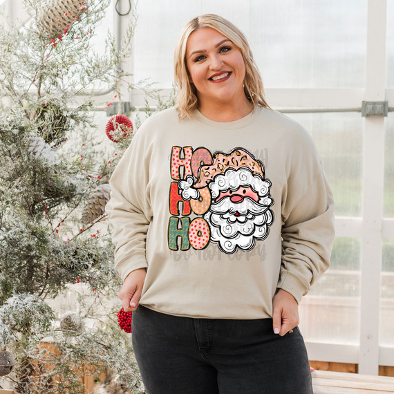 Ho Ho Ho Santa Light Skin DTF Heat Transfer, festive holiday heat transfer design featuring Santa Claus with a colorful, cheerful 'Ho Ho Ho' message on a woman's sweatshirt.