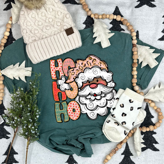 Ho Ho Ho Santa Dark Skin DTF Heat Transfer, Christmas-themed Santa face with the text 'Ho Ho Ho' on a teal sweatshirt.