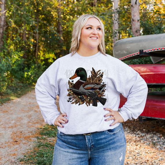 Camo Duck Faux Patch DTF Heat Transfer, woman wearing sweatshirt with duck and camouflage pattern design.