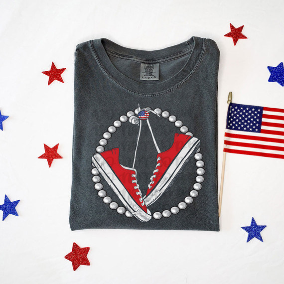Chucks & Pearls DTF Heat Transfer, graphic of red sneakers with pearl necklace outline on a gray T-shirt, surrounded by American flag themed stars and a small American flag on a stick.