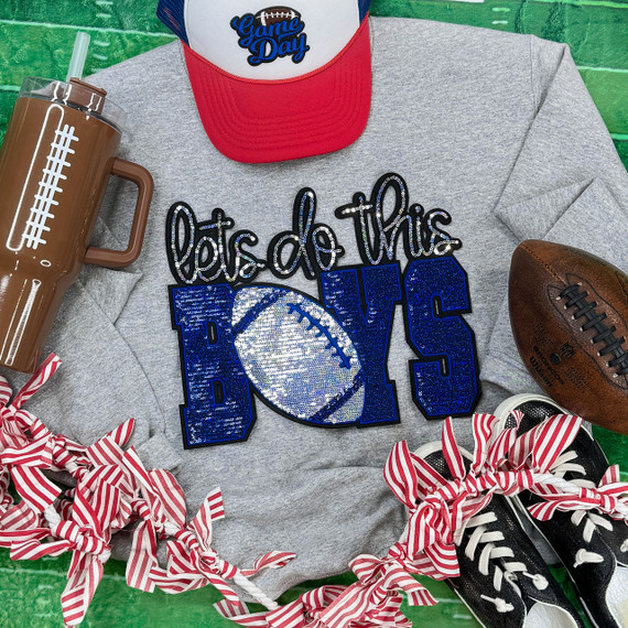 Let's Do This Boys Football Royal/Silver Sequins Patch, decorated with shiny sequins and embroidery on a gray T-shirt surrounded by sports accessories including a football, sneakers with striped laces, and a sports drink on a green background.