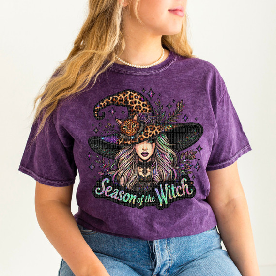 Season Of The Witch Light Skin DTF Heat Transfer, a vibrant purple t-shirt featuring a detailed witch with long hair wearing a large leopard print witch hat adorned with a cat and decorative elements.