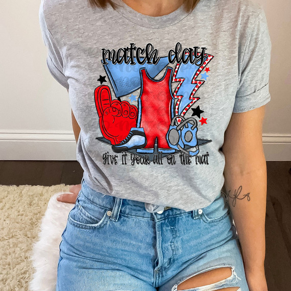 Match Day Give It Your All On The Mat Red/Light Blue DTF Heat Transfer, graphic T-shirt featuring a red wrestling singlet, a foam finger, a whistle, and lightning bolts for sports enthusiasm.