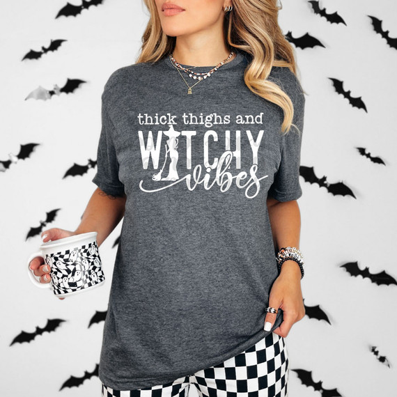Thick Thighs And Witchy Vibes WHITE DTF Heat Transfer, product description of a white heat transfer design with witchy and bold lettering on a dark grey t-shirt.