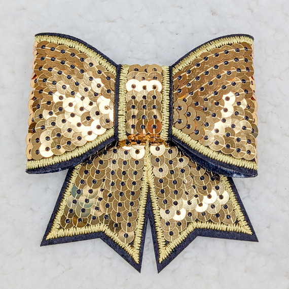 Gold Sequin Bow HAT/POCKET Patch, decorative gold sequined bow with black and yellow embroidered edges and a small gold and black sequined patch in the center.