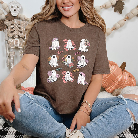 Hey Boo Hey Boo Ghosts DTF Heat Transfer, a cute Halloween-themed graphic t-shirt featuring cartoon ghost characters with floral accents and the words 'Hey' and 'Boo' in colorful text.