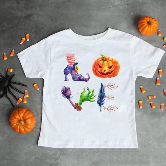 LOVE Halloween Word Art Sublimation Transfer, Halloween-themed artwork printed on a white T-shirt with pumpkins, a spider, and Halloween decorations around it.