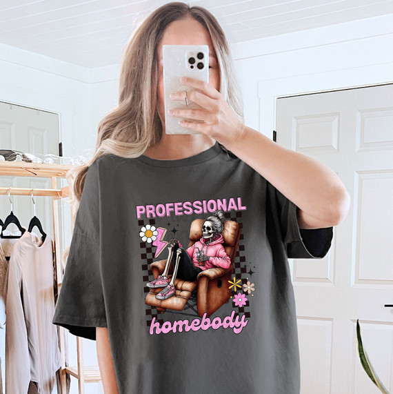 Professional Homebody Skeleton DTF Heat Transfer, a graphic design of a skeleton person sitting on a chair with casual clothing and accessories, with colorful decorative elements.