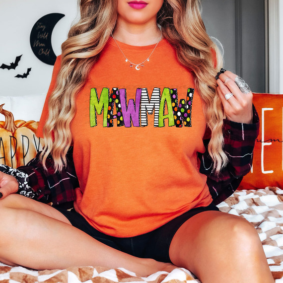 Mawmaw Halloween Letters DTF Heat Transfer, colorful Halloween-themed text design on an orange t-shirt.