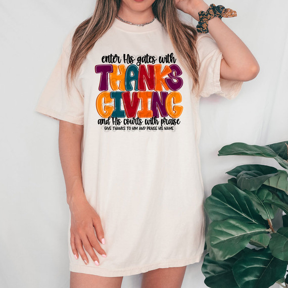 Enter His Gate With Thanksgiving And His Courts With Praise DTF Heat Transfer, colorful graphic design on a white T-shirt worn by a woman.