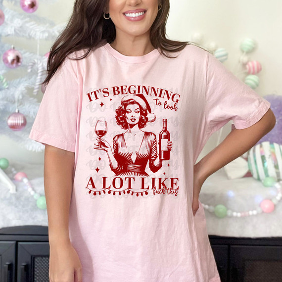 It's Beginning To Look A Lot Like Fuck This RED DTF Heat Transfer, graphic t-shirt featuring a retro woman holding a wine glass and bottle for holiday or casual wear.