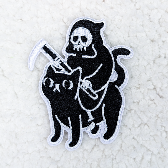 Grim Reaper Cat Embroidered HAT/POCKET Patch, black cat with a hood and skull face riding a black cat with an embroidered scythe and holding a white paintbrush.