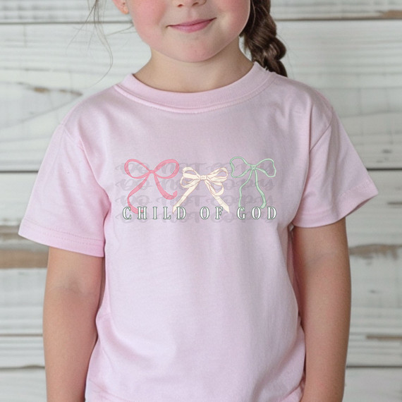 Child Of God Coquette Bows DTF Heat Transfer, pink t-shirt with pastel-colored bow designs and text.