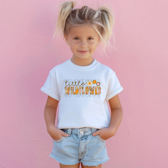 Little Wildflower DTF Heat Transfer, on a young girl wearing a white t-shirt with floral text design