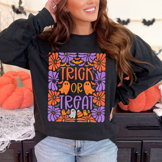 Trick Or Treat Floral DTF Heat Transfer, Halloween-themed colorful floral design with pumpkins, bats, and ghosts on a black sweatshirt.