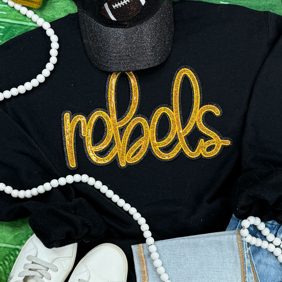 Rebels Gold Sequin Patch, a gold sequined patch with the word 'Rebels' embroidered in cursive on a black fabric background.
