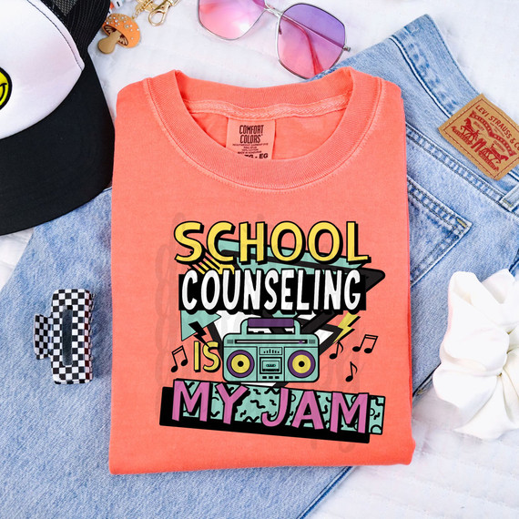 School Counseling Is My Jam DTF Heat Transfer, colorful graphic T-shirt with retro music theme and boombox design, laid on denim with accessories.