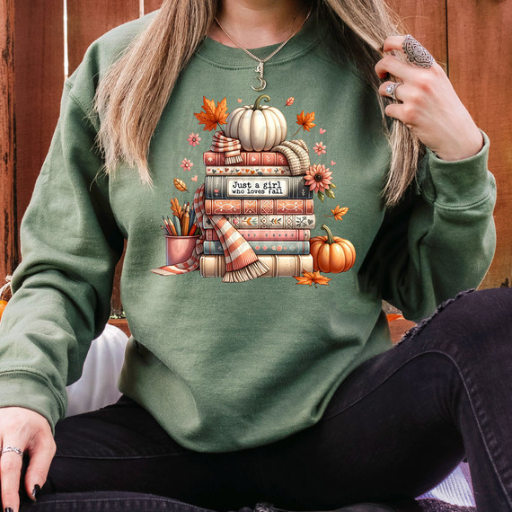 Just A Girl Who Loves Fall Books DTF Heat Transfer, autumn-themed graphic design on a green sweatshirt featuring pumpkins, fall leaves, books, and cozy elements.