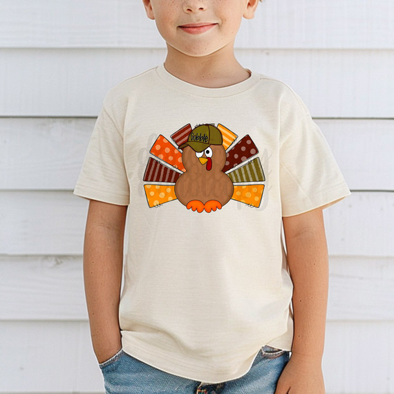 Boy Turkey DTF Heat Transfer, colorful turkey design with a baseball cap on a child's T-shirt.