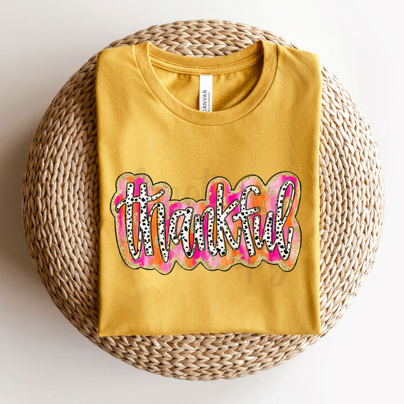 Thankful Brushstroke Faux Glitter DTF Heat Transfer, colorful thank you design on a yellow t-shirt.