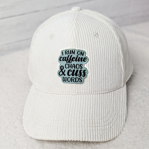 I Run On Caffeine and Chaos FAUX Leather Patch baseball cap, white corduroy cap with embroidered patch featuring humorous quote in stylish black and teal font.