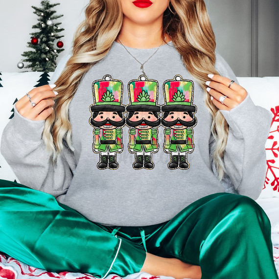 Brushstroke Nutcrackers DTF Heat Transfer, colorful nutcracker design on a woman's sweatshirt for holiday decoration.
