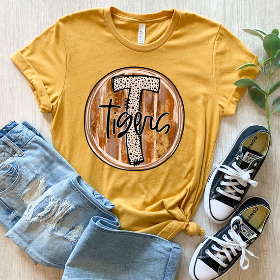 Tigers Fall Brushstrokes DTF Heat Transfer, yellow T-shirt with tiger stripe brushstroke circle design and the word Tigers written inside.