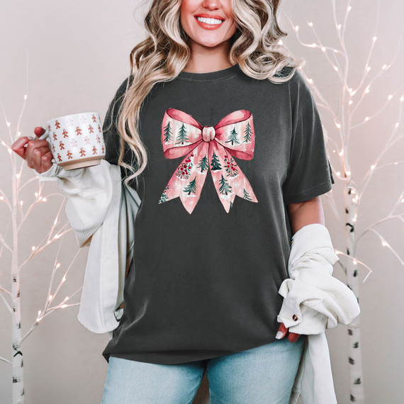 Pink Christmas Tree Bow DTF Heat Transfer, a vibrant pink bow with green pine trees and holiday accents, used for decorating Christmas apparel and accessories.