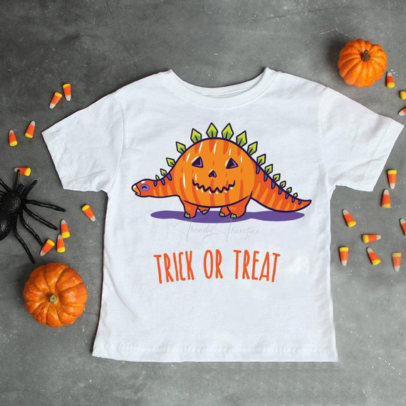 Pumpkin Stegosaurus trick or treat dino sublimation transfer on a white T-shirt, Halloween themed design.