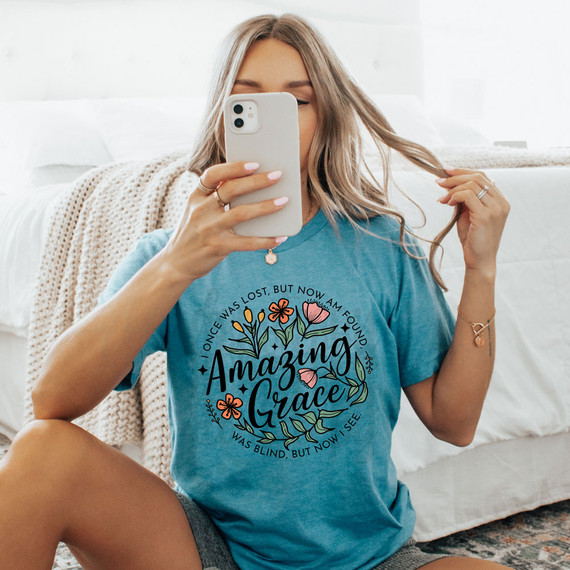 I Once Was Lost, But Now Am Found DTF Heat Transfer, a product featuring a floral design with inspirational text on a woman wearing a blue T-shirt.