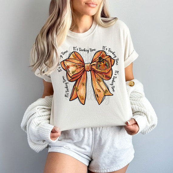 It's Turkey Time Thanksgiving Bow DTF Heat Transfer, a festive design featuring an orange ribbon bow with fall leaves and a cute turkey wearing a pilgrim hat, perfect for Thanksgiving decorations and apparel.
