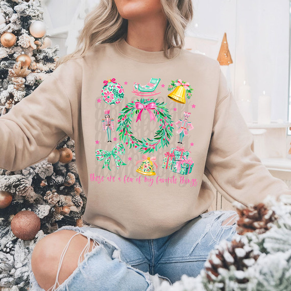 Favorite Things Christmas DTF Heat Transfer, colorful holiday-themed design for clothing including a wreath, Christmas ornaments, gingerbread cookies, presents, and festive decorations.