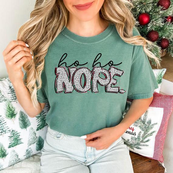 Ho Ho Nope, DTF Heat Transfer, featuring a woman wearing a green T-shirt with the text "ho ho NOPE" in festive style, used for creative holiday apparel and decoration.