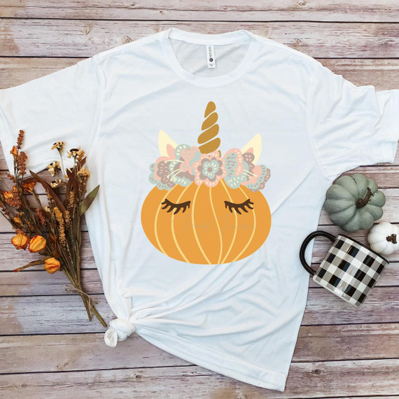 Unicorn Pumpkin Sublimation Transfer, decorative pumpkin with unicorn horn and floral crown embroidery design on a white t-shirt.