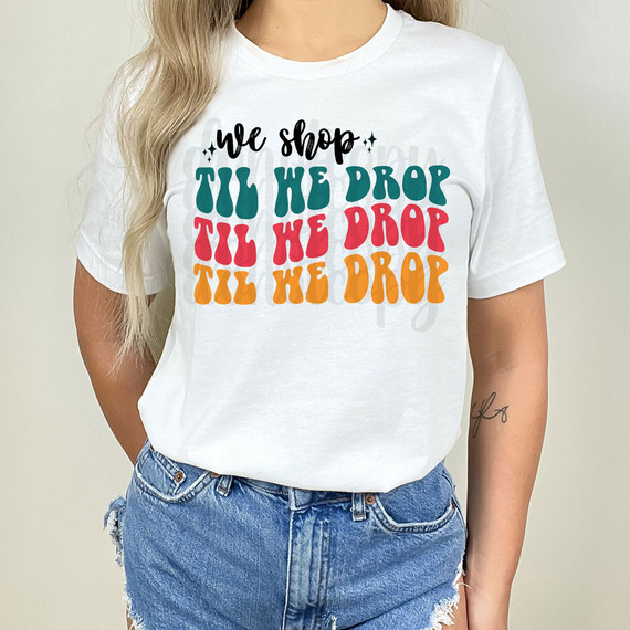 We Shop Til We Drop DTF Heat Transfer, colorful graphic T-shirt design on a white shirt.