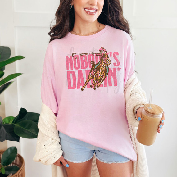 Nobody's Darlin DTF Heat Transfer, pink sweatshirt with cowboy girl riding a horse graphic.