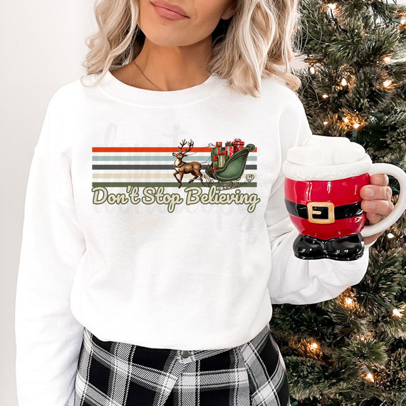 Don't Stop Believing Vintage DTF Heat Transfer, Christmas themed sweatshirt with reindeer, sleigh, and presents design.