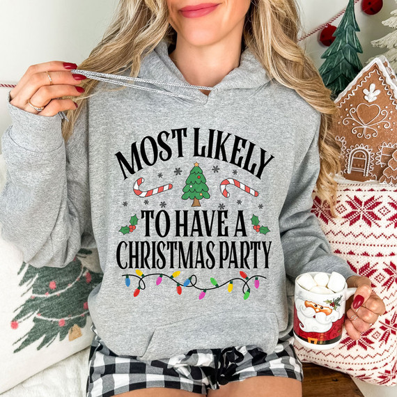 Most Likely To Have A Christmas Party Festive DTF Heat Transfer, decorated with holiday-themed graphics including a Christmas tree, candy canes, holly, and colorful lights.