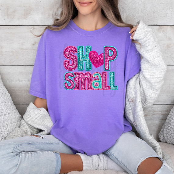 Shop Small Faux Sequins DTF Heat Transfer, colorful sequin embellished text on purple T-shirt featuring 'SHOP SMALL' with a heart symbol in the middle.