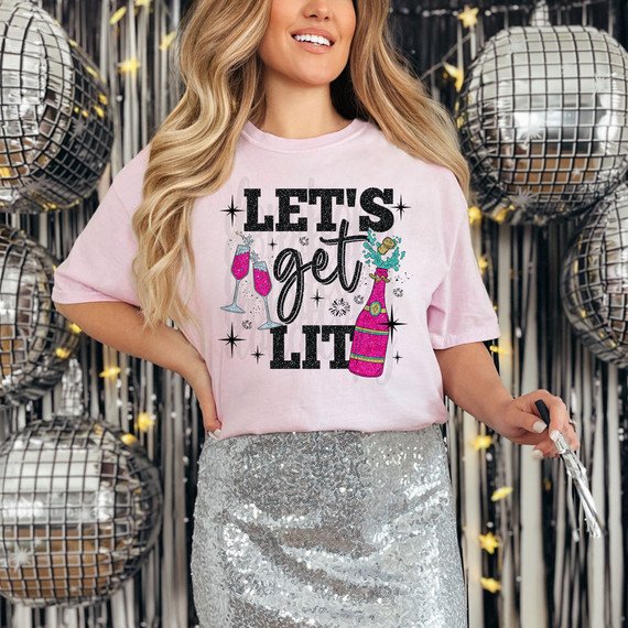 Let's Get Lit Faux Glitter DTF Heat Transfer, woman wearing a pink t-shirt with birthday celebration design, surrounded by silver disco balls.