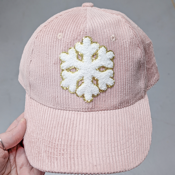 White Snowflake Chenille & Glitter HAT/POCKET Patch, pink corduroy cap with a white fluffy snowflake patch outlined in gold on front.